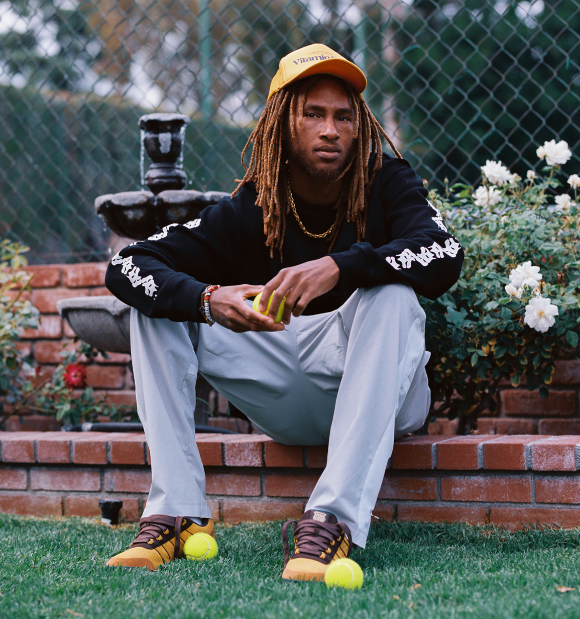 Anwar sitting in the park with GSTADD KSRC shoes
